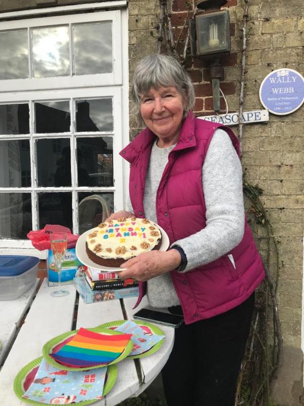 Pam with a her birthday cake with the word Granny on the top